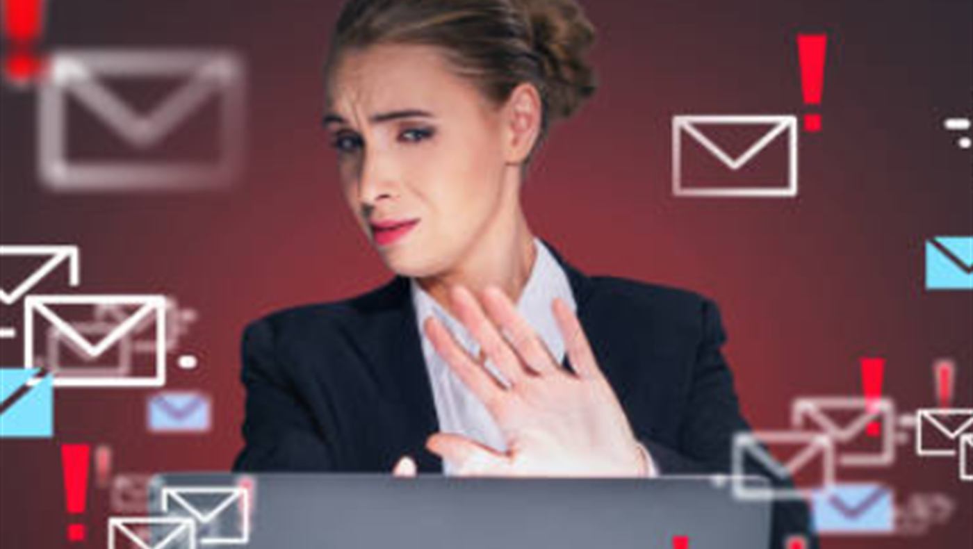A person at a laptop surrounded by floating email and alert icons
