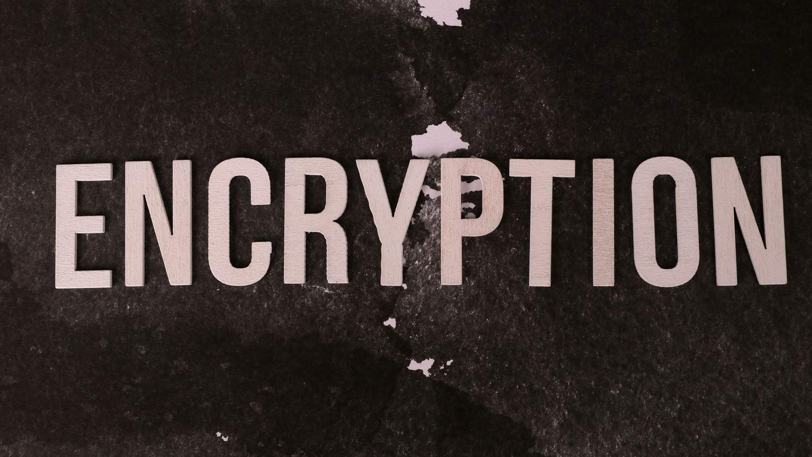 The word encryption set in stencil type on a worn surface